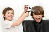 Zwei Jungs spielen Friseur und schneiden sich die Haare selber
