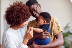 Glückliche Eltern mit Baby auf dem Arm