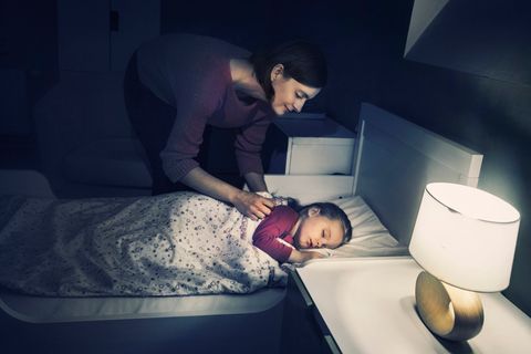 Mutter bringt ihre Tochter zu Bett