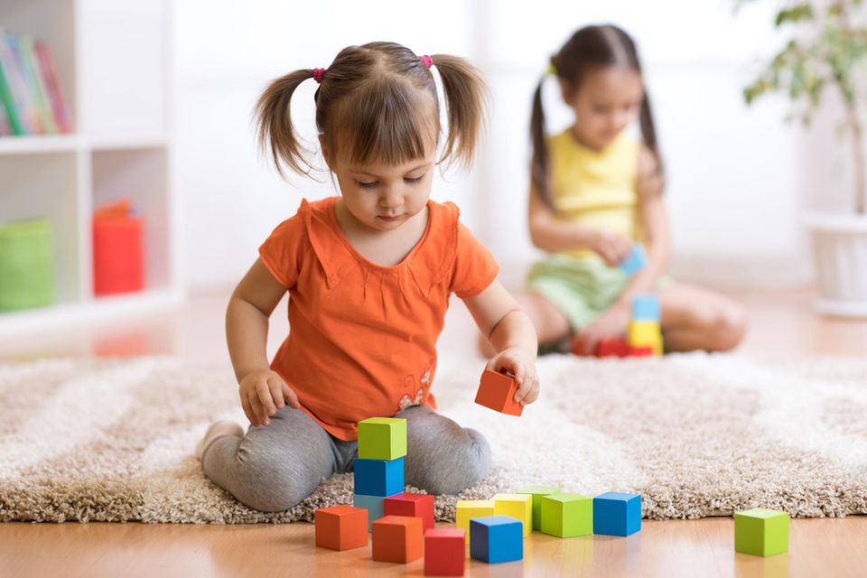 Mädchen spielt mit Bauklötzen