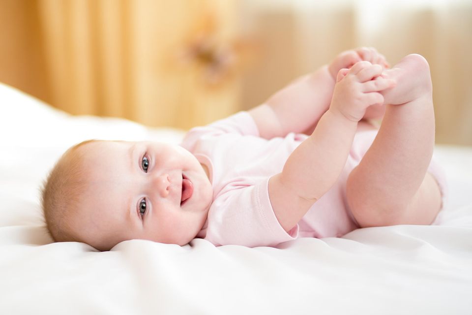 Woran erkennen Baby Lebewesen? Baby liegt auf Bett