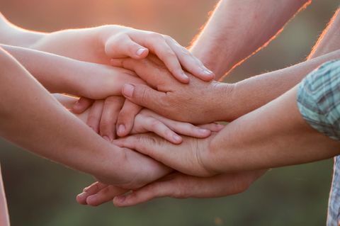 ELTERN-Studie 2022: Familie legt Hände aufeinander