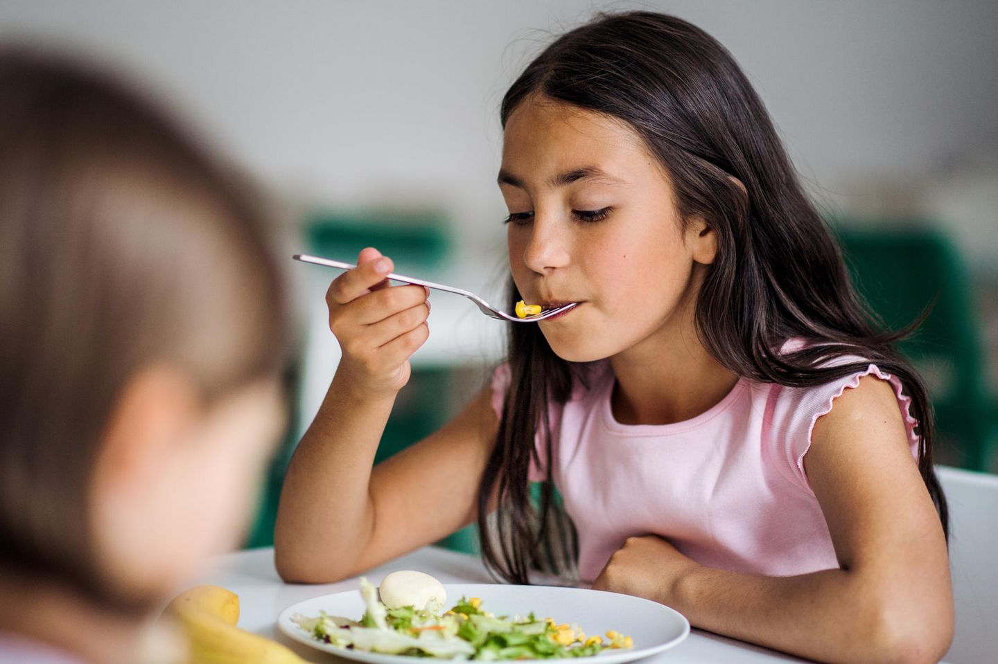 Essstörungen im Kinder- und Jugendalter frühzeitig erkennen: Mädchen isst ihr Essen