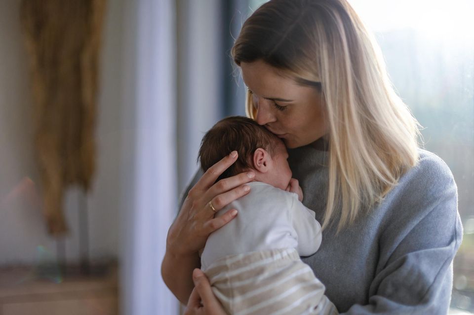 Dinge, durch die dein Baby sich geliebt fühlt: Mutter küsst Baby